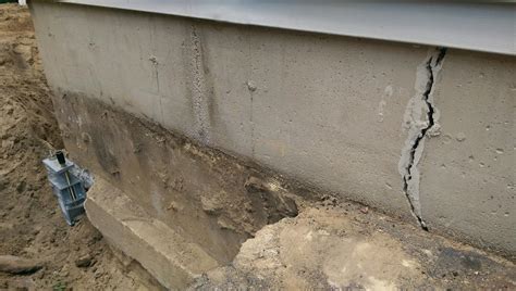 The wall separates the house from its garage. . Crack in garage foundation wall